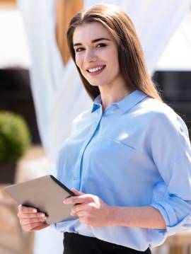 Smiling Girl Holding an Ipad Looking for Storage Units in Evansville